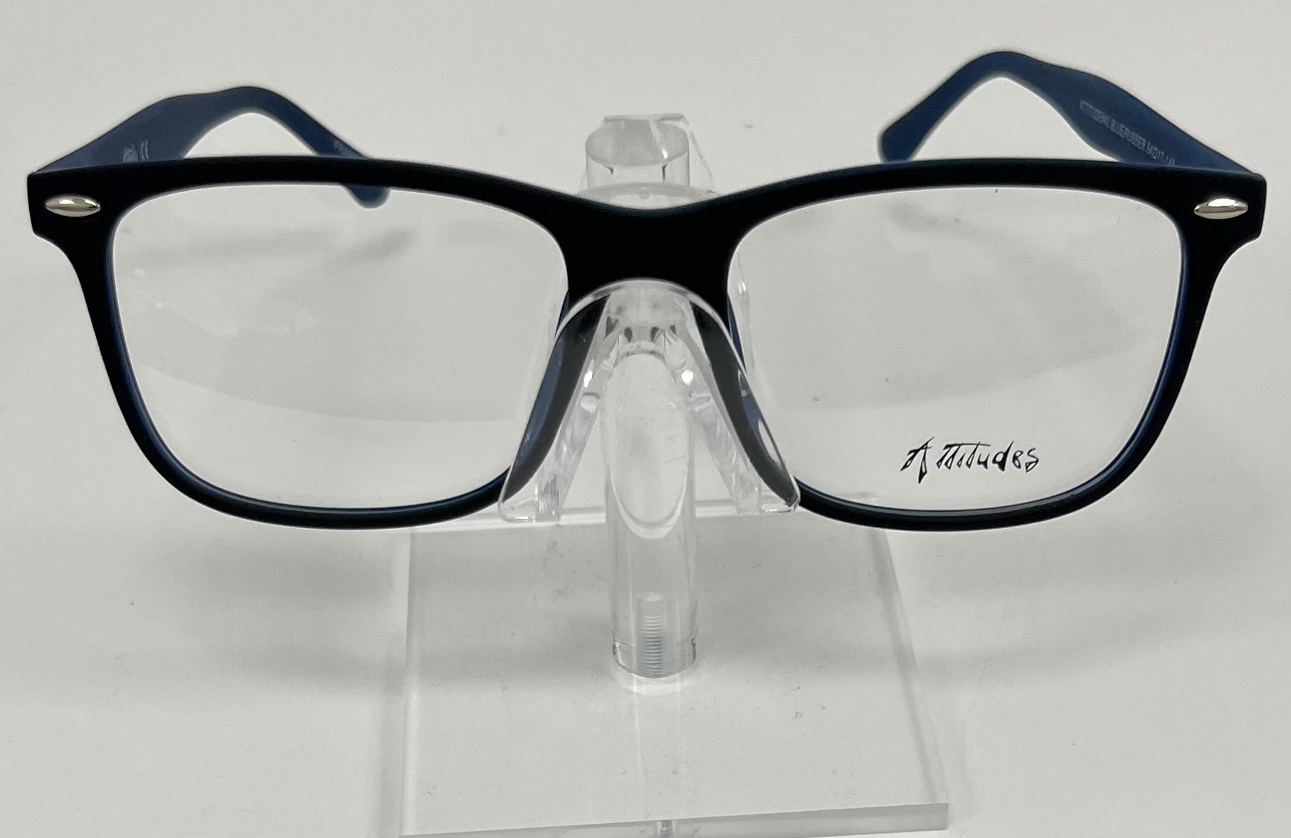 blue eyeglasses on a clear stand with 'Attitudes' branding.