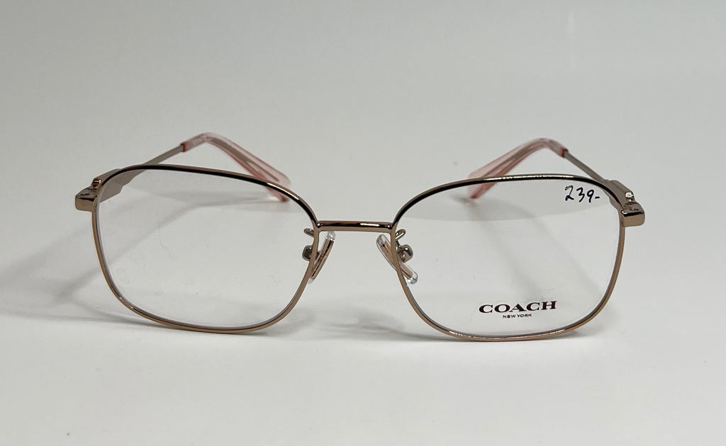 Coach eyeglasses with a metallic rose gold frame and clear lenses, featuring the Coach logo on the lower right lens and a handwritten price of 23.99 on the upper right lens.