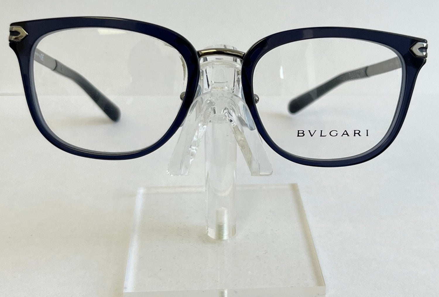 Bulgari eyeglasses on a clear stand against a white background