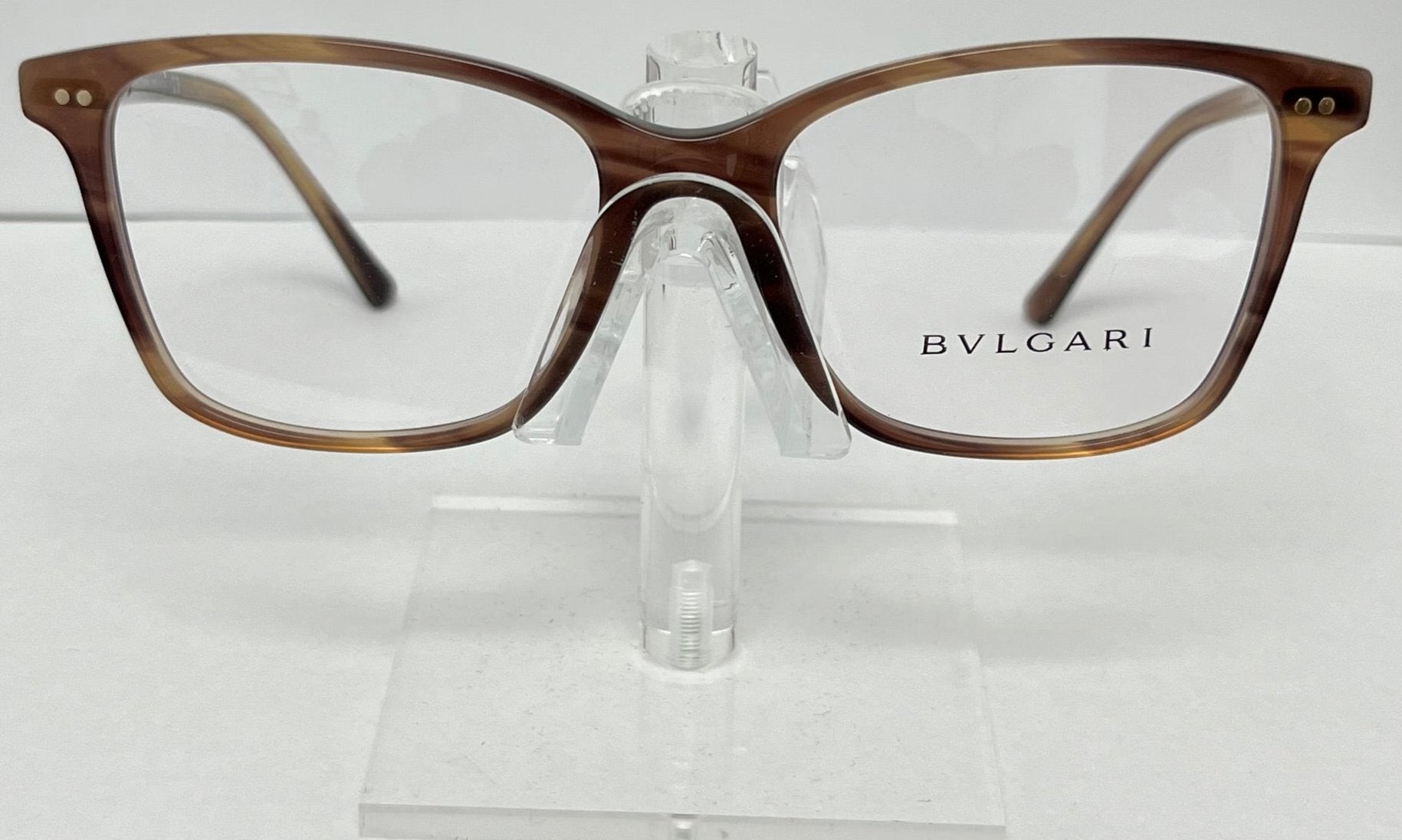 Bulgari eyeglasses on a clear stand against a white background