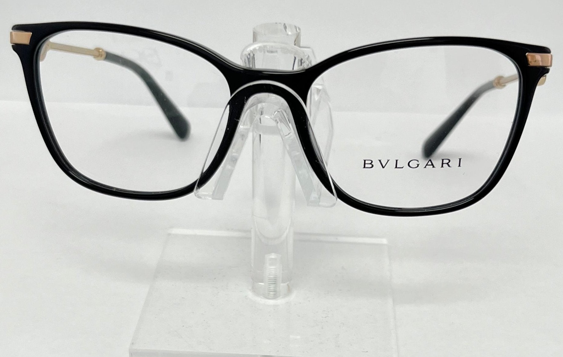 Bulgari eyeglasses on a clear stand against a white background