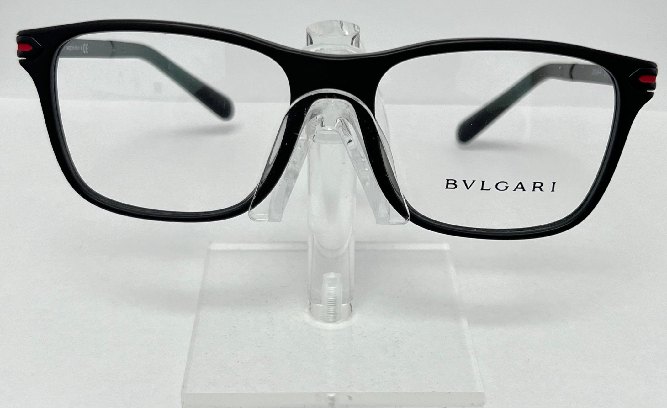 Bulgari eyeglasses on a clear stand against a white background