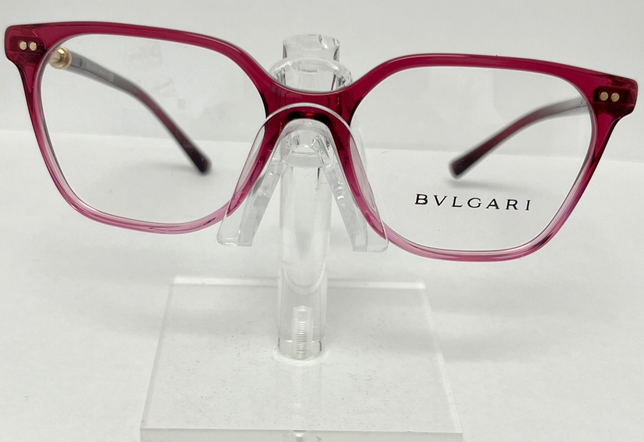Bulgari eyeglasses on a clear stand against a white background