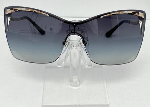 Sunglasses with a gradient lens on a clear stand against a white background