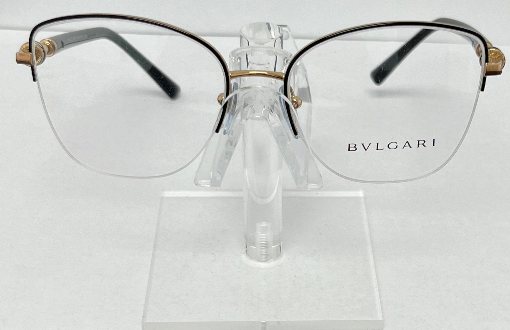 Bulgari eyeglasses on a clear stand against a white background