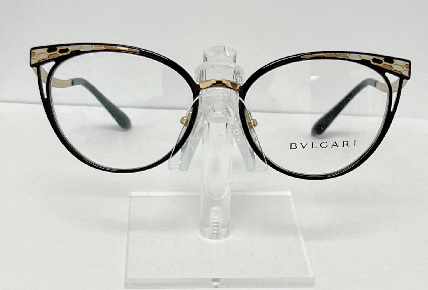 Bulgari eyeglasses on a clear stand against a white background