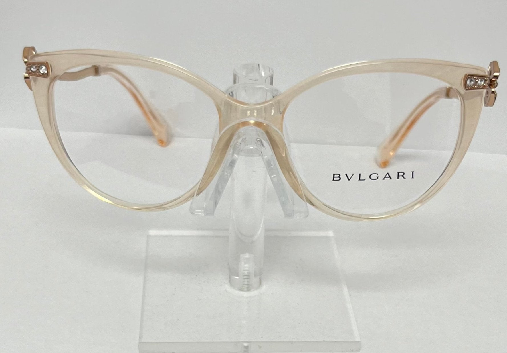 Bulgari eyeglasses on a clear stand against a white background