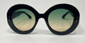 Black sunglasses with round lenses on a white background