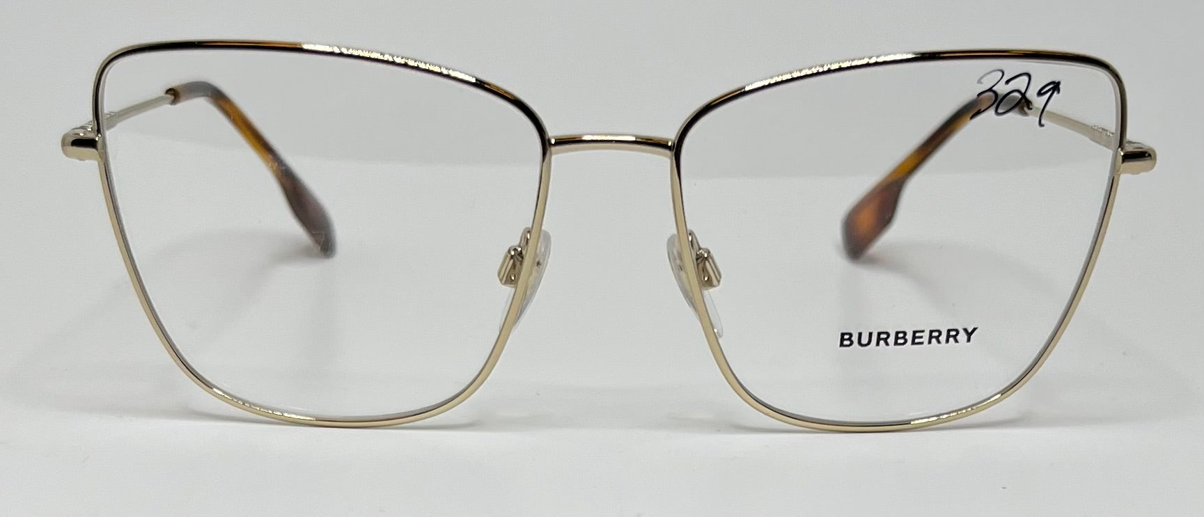 Gold Burberry eyeglasses on a white background