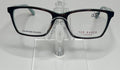 A pair of Ted Baker brand eyeglasses with a red and tortoise color scheme, displayed on a clear stand.