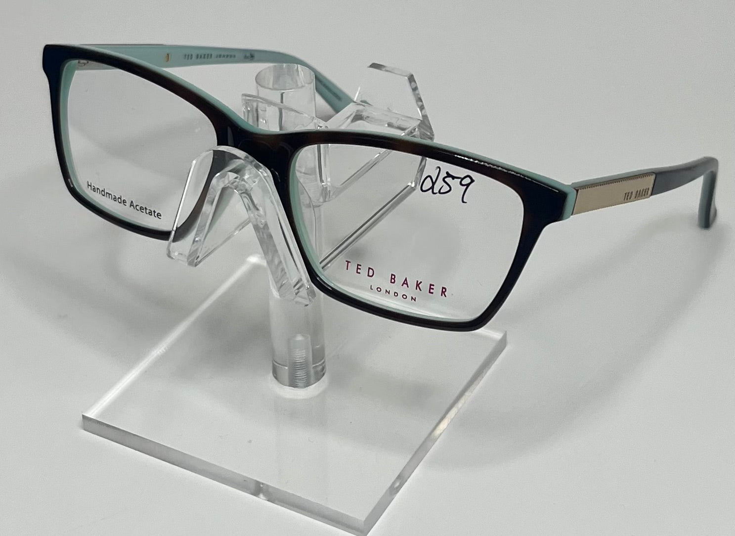 Black-rimmed eyeglasses on a clear stand