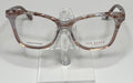 A pair of Ted Baker eyeglasses with transparent pink frames on a display stand.